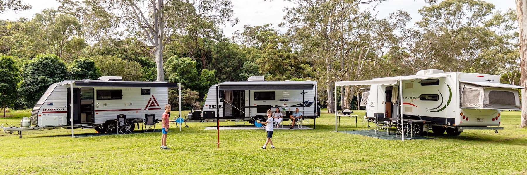 Family caravans set up at an Australian bush campsite